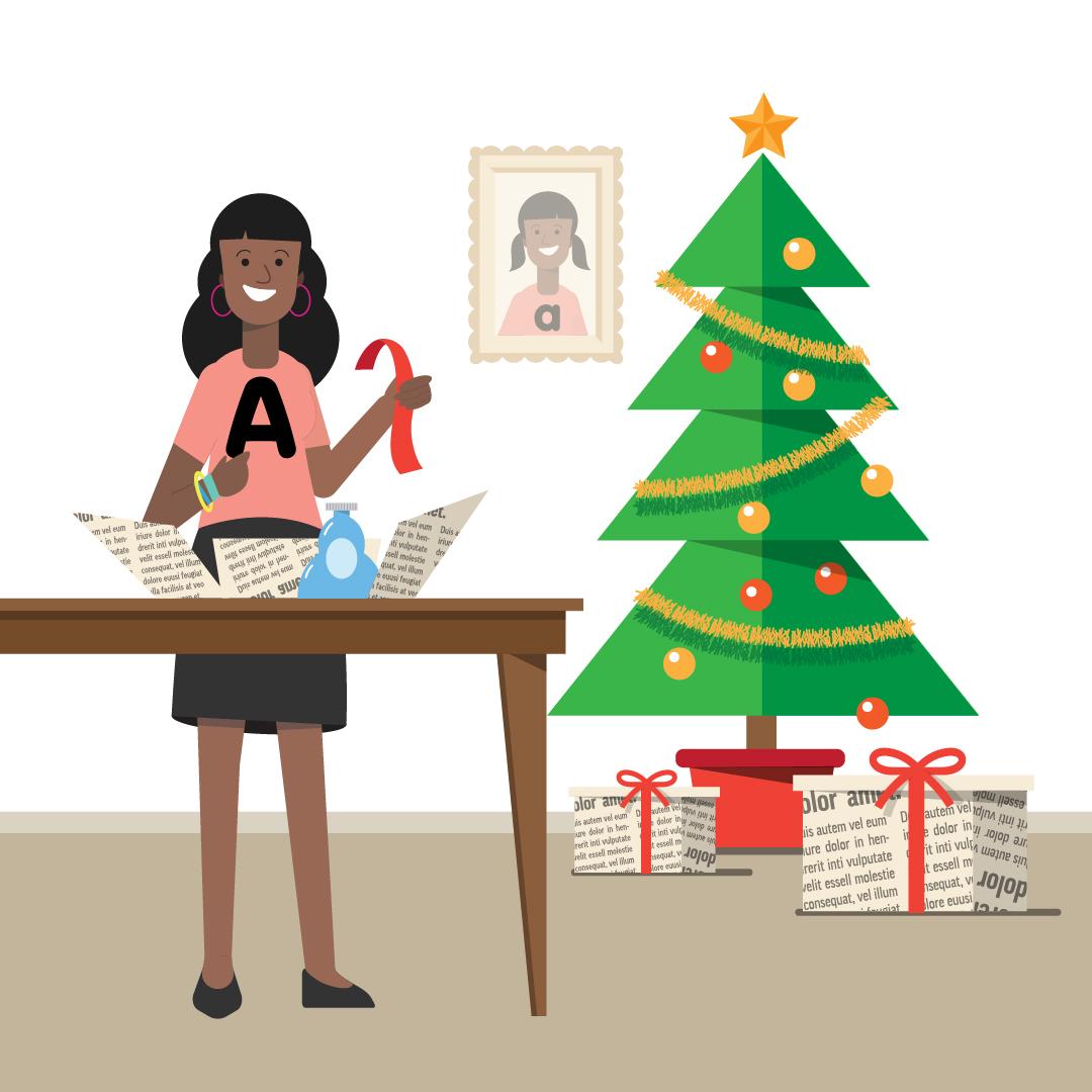 Girl wrapping a gift next to a christmas tree